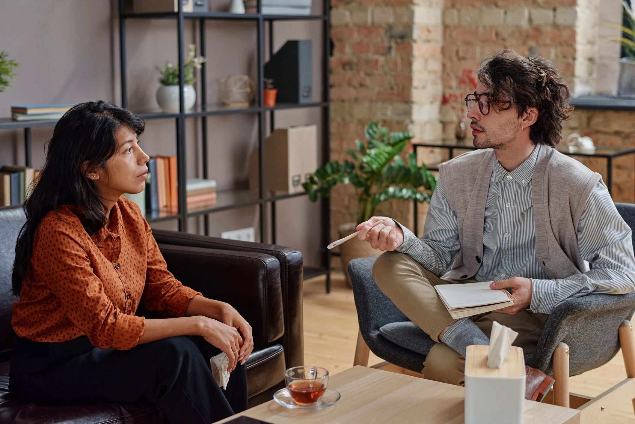 Therapist speaking with a client in a wellness office