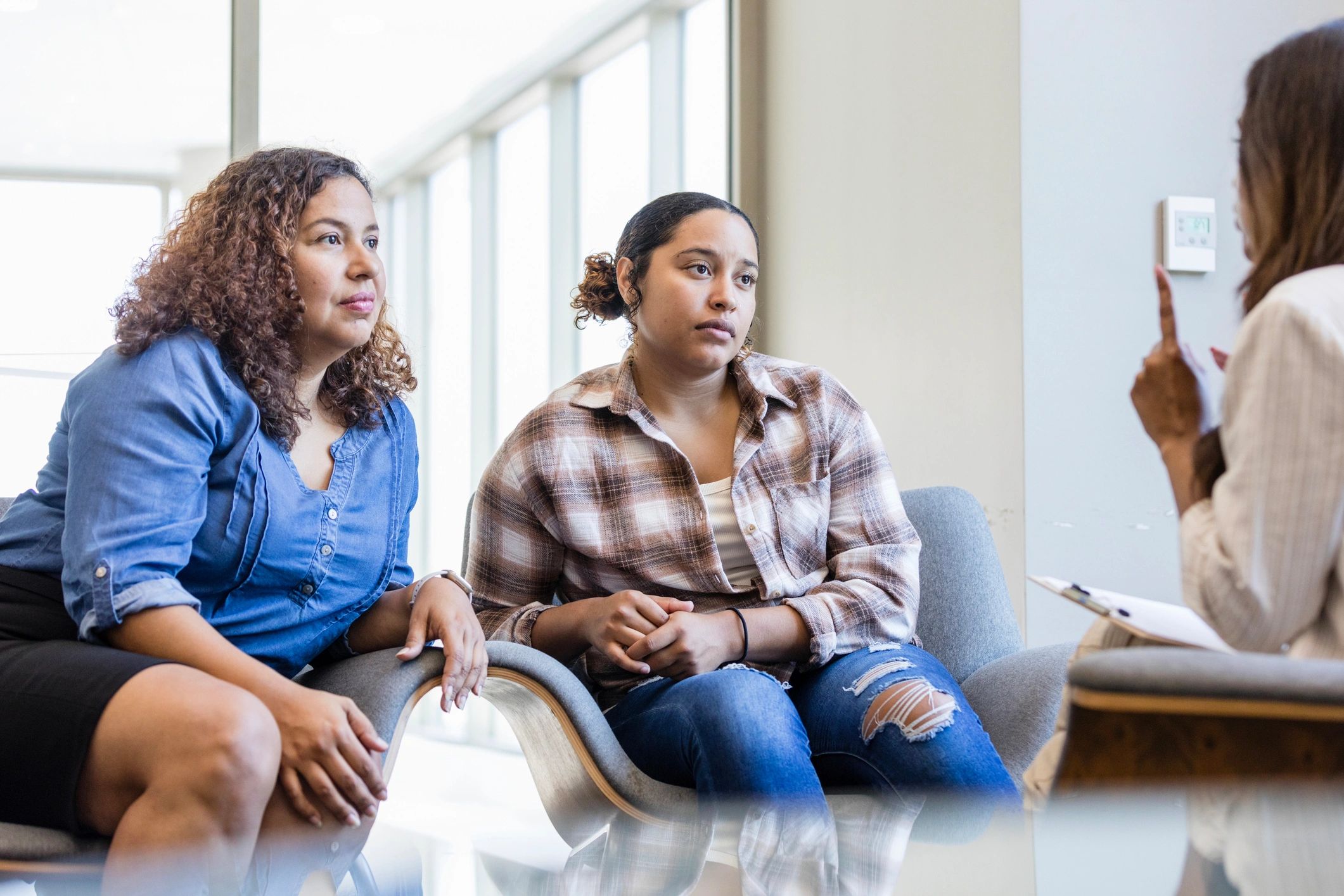 Therapist speaking with parent and child during a coaching session