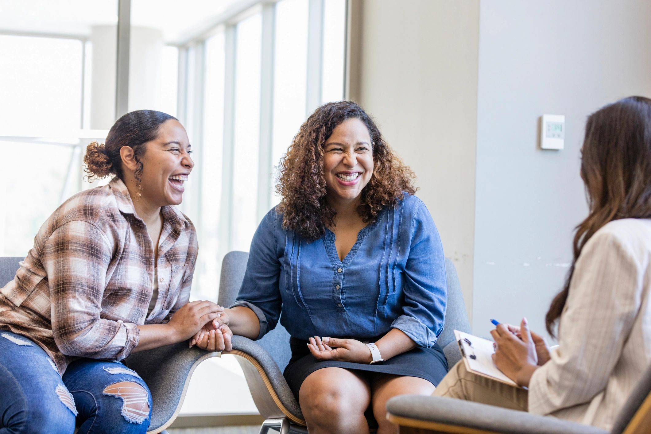 Mother and daughter smiling during a counseling session